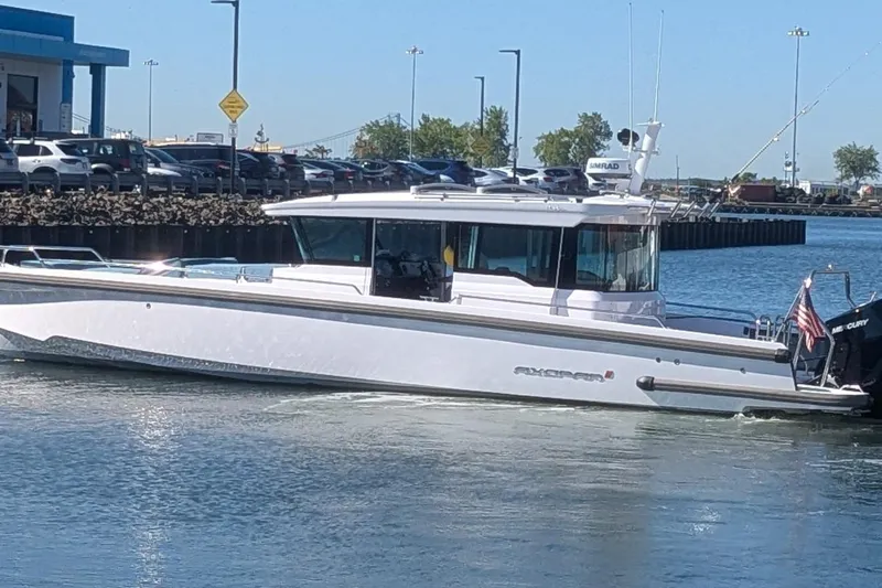 Nocellara De Belice Yacht Photos Pics 2024 Axopar 37 Cross Cabin with Bench Seat, V10s, cruising in a marina.