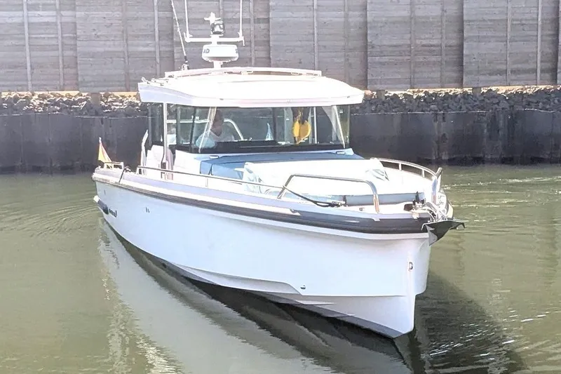 Nocellara De Belice Yacht Photos Pics 2024 Axopar 37 Cross Cabin boat with bench seat, cruising in calm waters.
