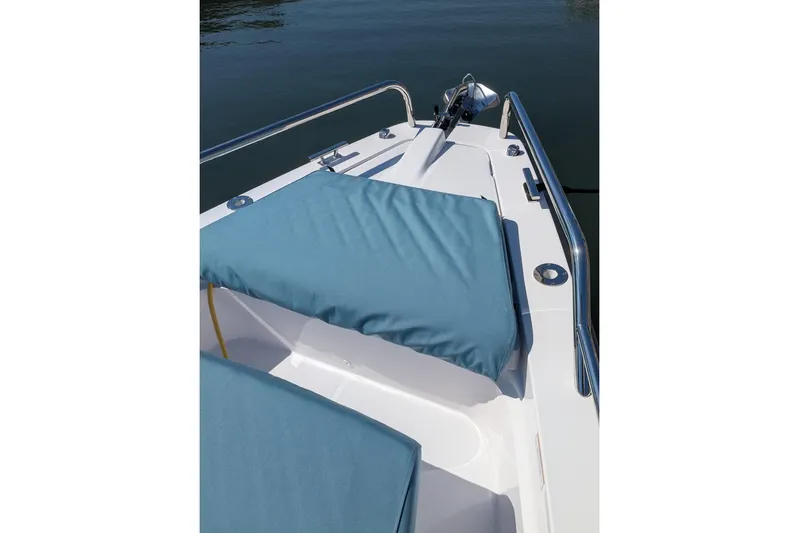 Nocellara De Belice Yacht Photos Pics 2024 Axopar 37 Cross Cabin boat with blue bench seat, docked on calm water.