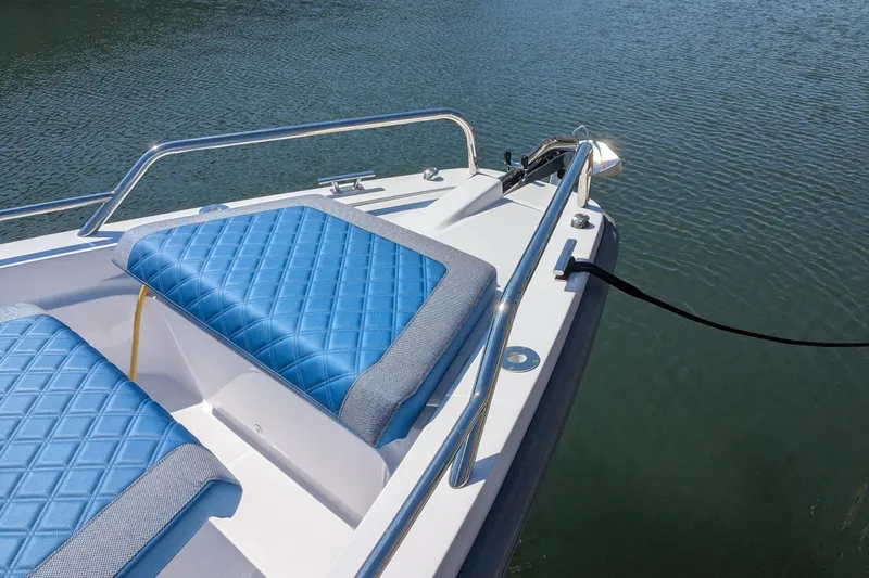 Nocellara De Belice Yacht Photos Pics 2024 Axopar 37 Cross Cabin with blue bench seat on calm water.