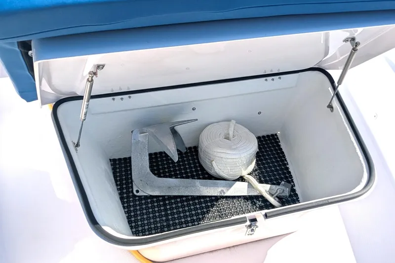Nocellara De Belice Yacht Photos Pics Open storage compartment on 2024 Axopar 37 Cross Cabin, featuring anchor and rope.