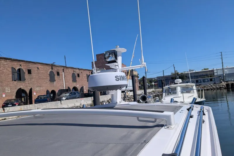 Nocellara De Belice Yacht Photos Pics 2024 Axopar 37 Cross Cabin with Bench Seat, docked near brick building.