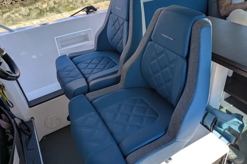 Nocellara De Belice Yacht Photos Pics 2024 Axopar 37 Cross Cabin interior with blue diamond-stitched bench seats.