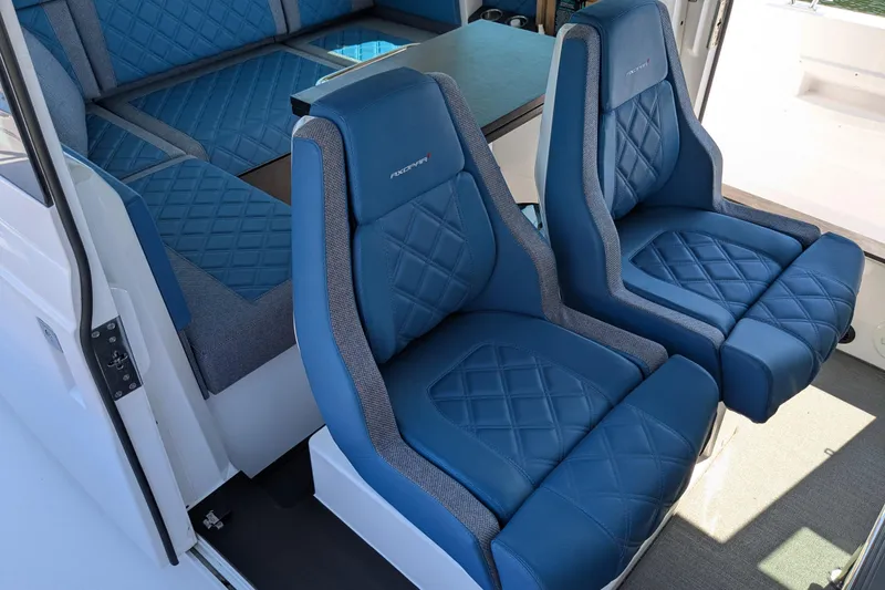 Nocellara De Belice Yacht Photos Pics 2024 Axopar 37 Cross Cabin interior with blue quilted bench seats.