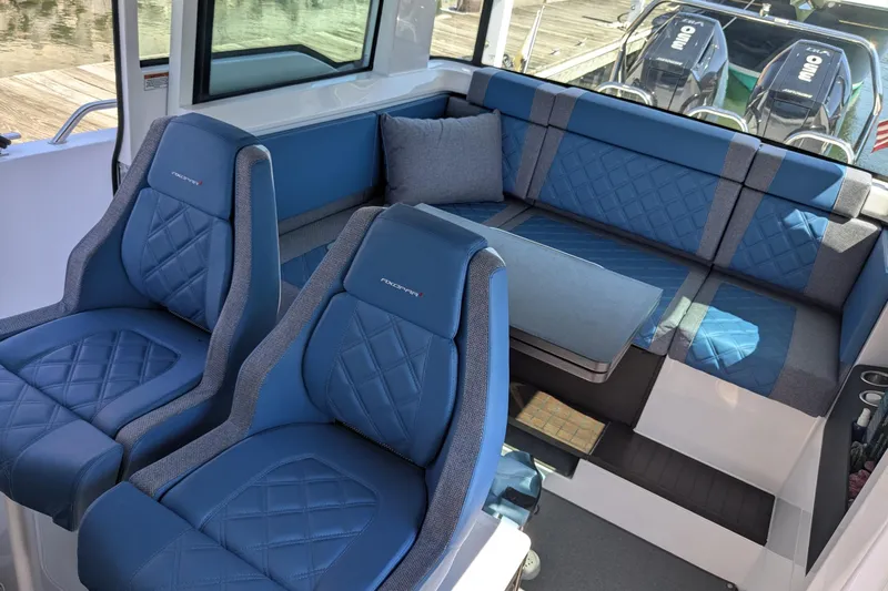 Nocellara De Belice Yacht Photos Pics 2024 Axopar 37 Cross Cabin interior with blue quilted seats and bench.