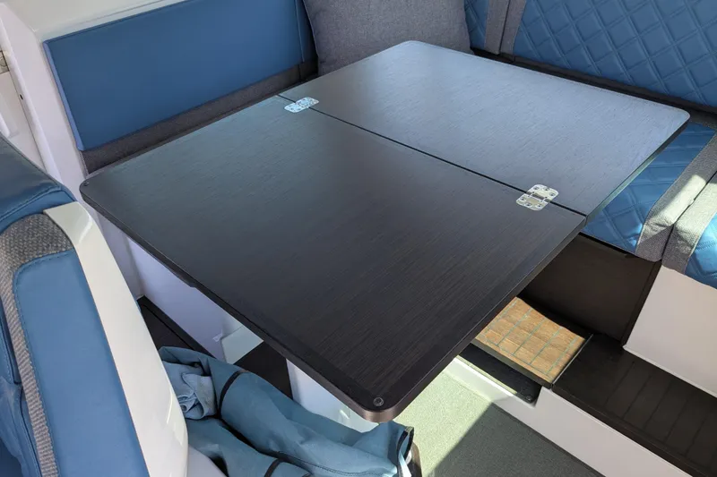 Nocellara De Belice Yacht Photos Pics 2024 Axopar 37 Cross Cabin interior with bench seat and foldable table.