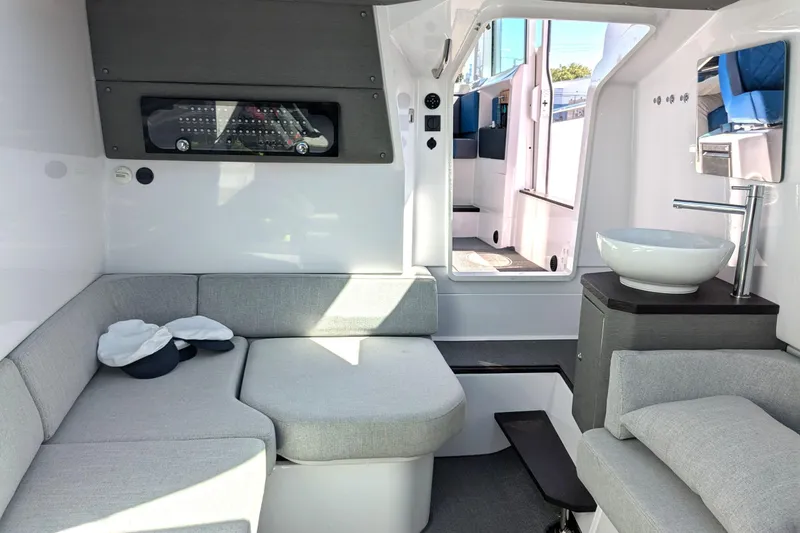 Nocellara De Belice Yacht Photos Pics 2024 Axopar 37 Cross Cabin interior with bench seat and modern amenities.