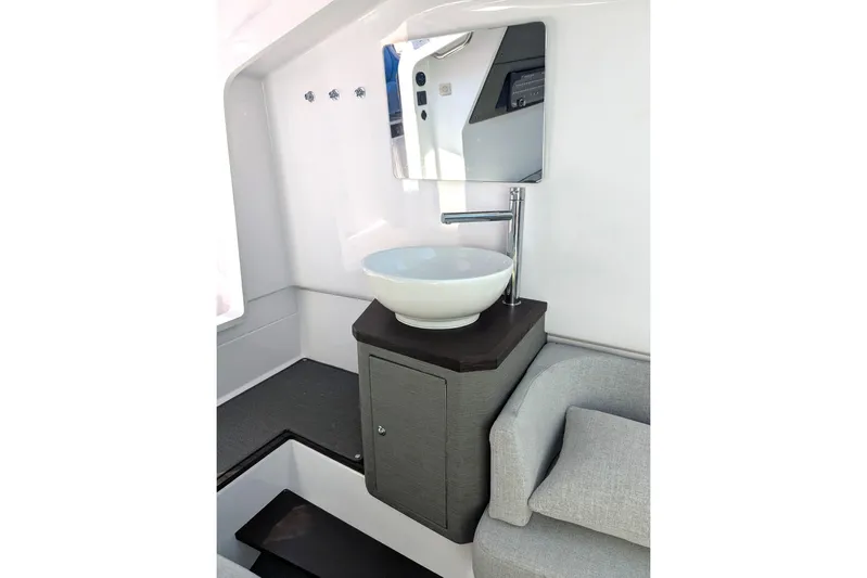 Nocellara De Belice Yacht Photos Pics Modern bathroom interior of 2024 Axopar 37 Cross Cabin boat with sleek sink and mirror.