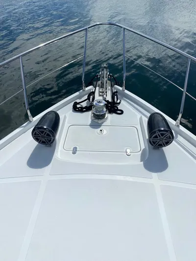  Yacht Photos Pics 2006 Pershing 50 yacht bow with anchor and speakers on calm water.