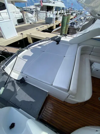  Yacht Photos Pics 2006 Pershing 50 yacht with spacious sun deck and luxurious seating at marina.