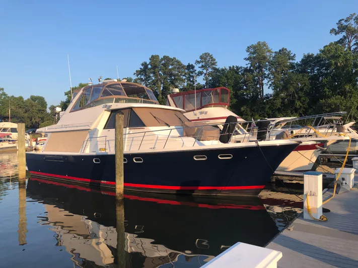 Joy Sea II Yacht Photos Pics 1997 Bayliner 4788 Pilot House Motoryacht docked at marina, surrounded by trees.