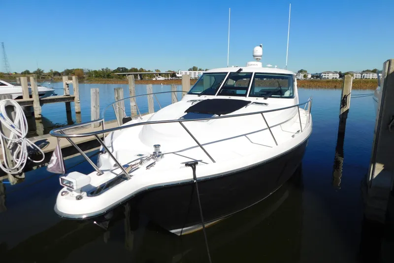  Yacht Photos Pics 2009 Tiara Yachts 4300 Sovran docked in a serene marina setting.