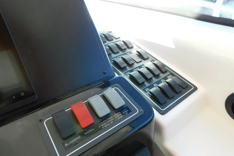  Yacht Photos Pics Control panel of a 2009 Tiara Yachts 4300 Sovran, featuring switches and buttons.