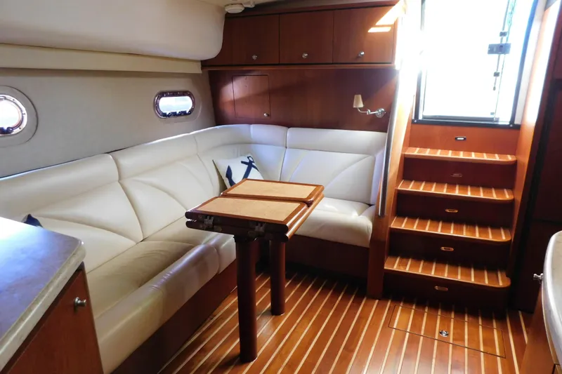  Yacht Photos Pics 2009 Tiara Yachts 4300 Sovran interior with white leather seating and wooden flooring.