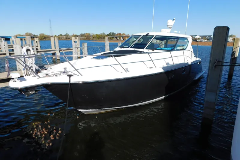 Yacht Photos Pics 2009 Tiara Yachts 4300 Sovran docked in a marina on a sunny day.