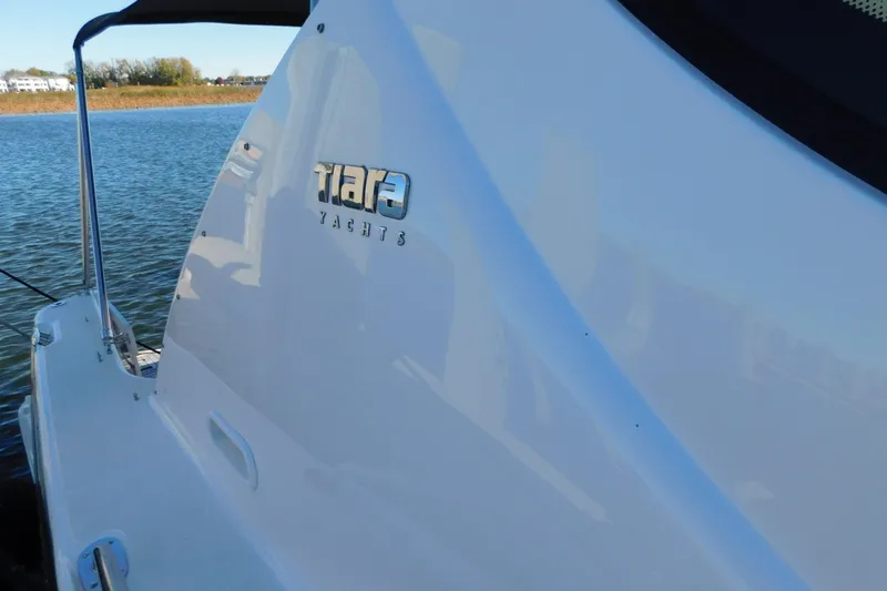  Yacht Photos Pics 2009 Tiara Yachts 4300 Sovran on calm water, showcasing sleek design and branding.