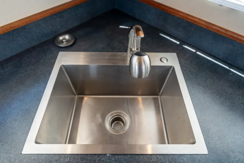 Cinnamon Girl Yacht Photos Pics Stainless steel sink with modern faucet in 2000 Nordic Tug 32 boat kitchen.