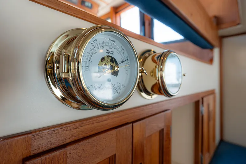 Cinnamon Girl Yacht Photos Pics Brass barometer and clock on 2000 Nordic Tug 32 interior wall.