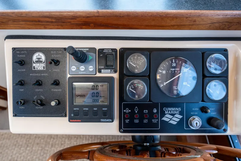 Cinnamon Girl Yacht Photos Pics Control panel of a 2000 Nordic Tug 32 with Cummins Marine gauges and switches.