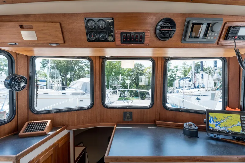 Cinnamon Girl Yacht Photos Pics Interior view of a 2000 Nordic Tug 32 boat with navigation equipment and windows.