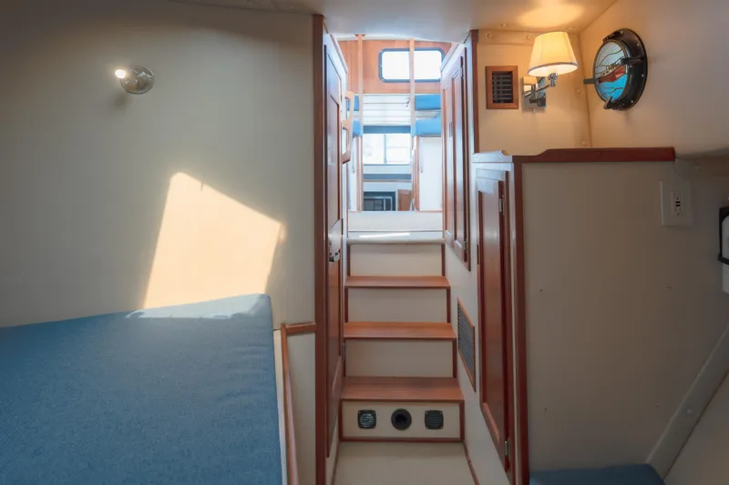 Cinnamon Girl Yacht Photos Pics Interior of a 2000 Nordic Tug 32, featuring cozy cabin stairs and nautical decor.