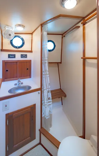 Cinnamon Girl Yacht Photos Pics Nordic Tug 32 (2000) bathroom with sink, shower, and wooden accents.