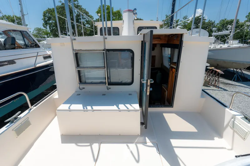 Cinnamon Girl Yacht Photos Pics Nordic Tug 32, 2000 model, open deck view with cabin entrance.