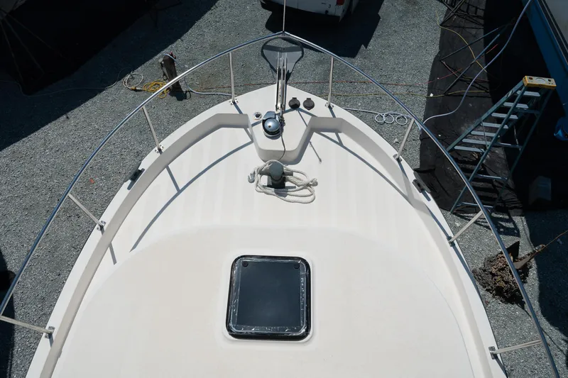 Cinnamon Girl Yacht Photos Pics Nordic Tug 32 (2000) boat deck with railing and hatch, viewed from above.