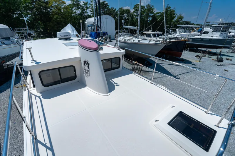 Cinnamon Girl Yacht Photos Pics Nordic Tug 32, 2000 model, docked in a marina with other boats.