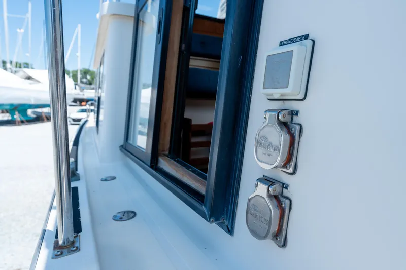 Cinnamon Girl Yacht Photos Pics Nordic Tug 32 boat exterior showing power outlets and phone cable port, 2000 model.