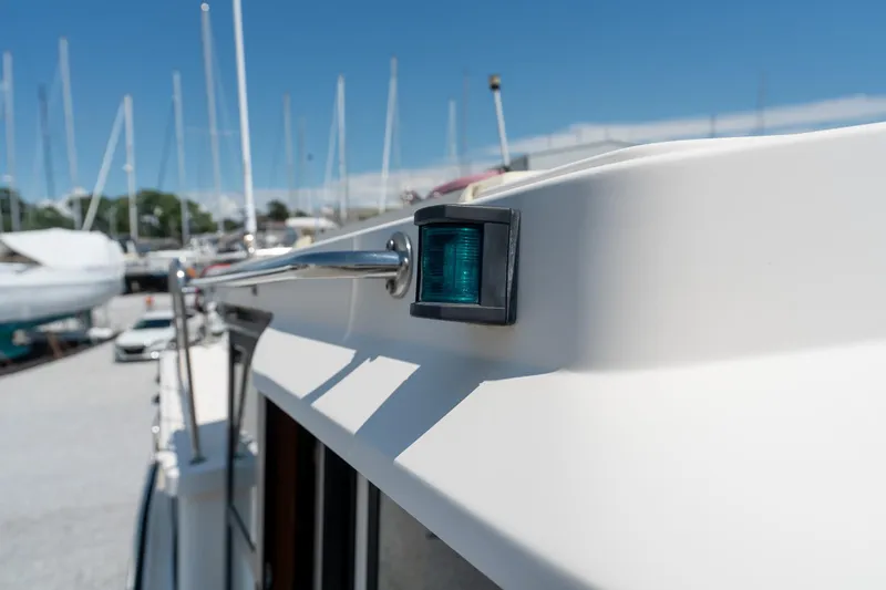 Cinnamon Girl Yacht Photos Pics Close-up of a 2000 Nordic Tug 32 boat's exterior with a navigation light.