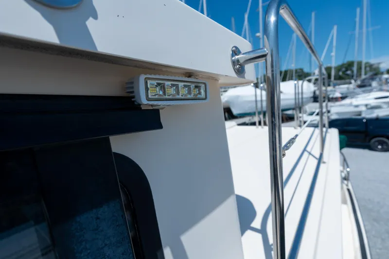 Cinnamon Girl Yacht Photos Pics Close-up of a 2000 Nordic Tug 32 boat's exterior with railing and LED light.