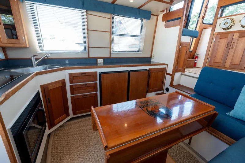 Cinnamon Girl Yacht Photos Pics Interior of a 2000 Nordic Tug 32, featuring a cozy kitchen and dining area.