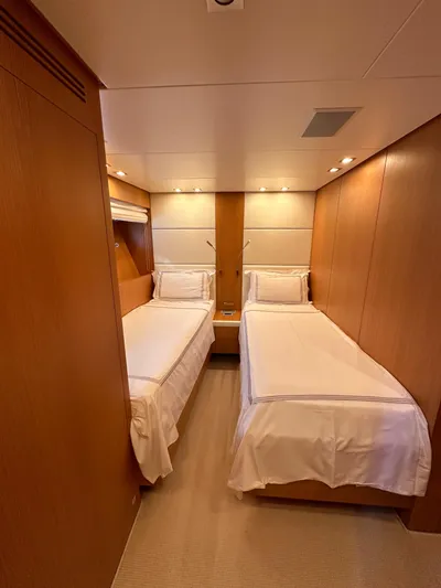  Yacht Photos Pics Twin bedroom on 2010 Sanlorenzo SL82 yacht with wooden paneling and modern lighting.