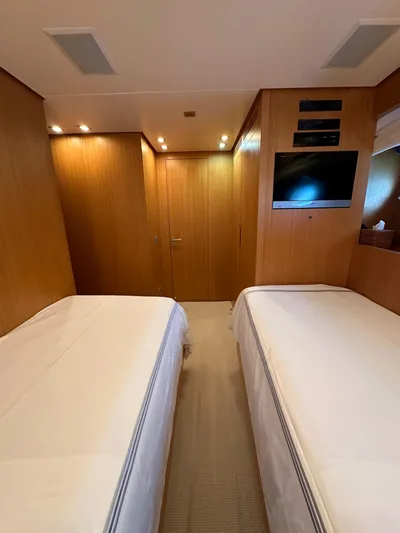  Yacht Photos Pics Twin bedroom in 2010 Sanlorenzo SL82 yacht with wood paneling and modern amenities.