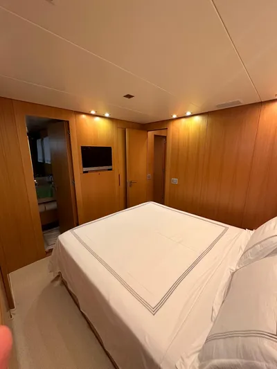  Yacht Photos Pics Luxurious bedroom interior of 2010 Sanlorenzo SL82 yacht with wood paneling and modern lighting.
