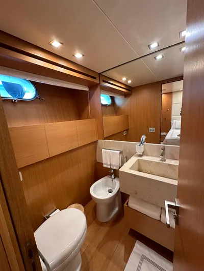  Yacht Photos Pics Luxurious Sanlorenzo SL82 2010 yacht bathroom with modern fixtures and wooden accents.