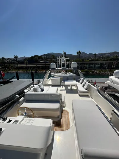  Yacht Photos Pics Sanlorenzo SL82 2010 yacht deck with seating, docked in a scenic marina.