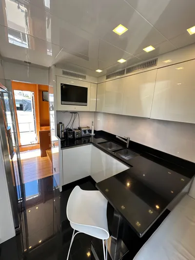  Yacht Photos Pics Modern kitchen interior on 2010 Sanlorenzo SL82 yacht with sleek black countertops.
