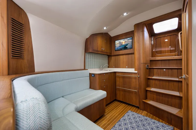 Karma Yacht Photos Pics Luxurious 2019 Winter Custom Yachts 46 Walkaround interior with wood finish and cozy seating.