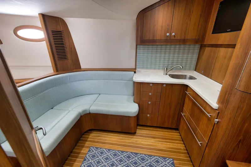 Karma Yacht Photos Pics Luxurious 2019 Winter Custom Yachts 46 Walkaround interior with wood cabinetry and cozy seating.