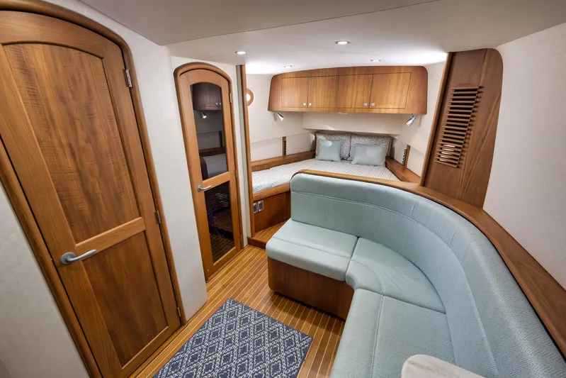 Karma Yacht Photos Pics Luxurious interior of 2019 Winter Custom Yachts 46 Walkaround with wood finishes and cozy seating.
