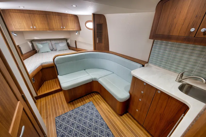 Karma Yacht Photos Pics Luxurious interior of 2019 Winter Custom Yachts 46 Walkaround with wood finish and cozy seating.