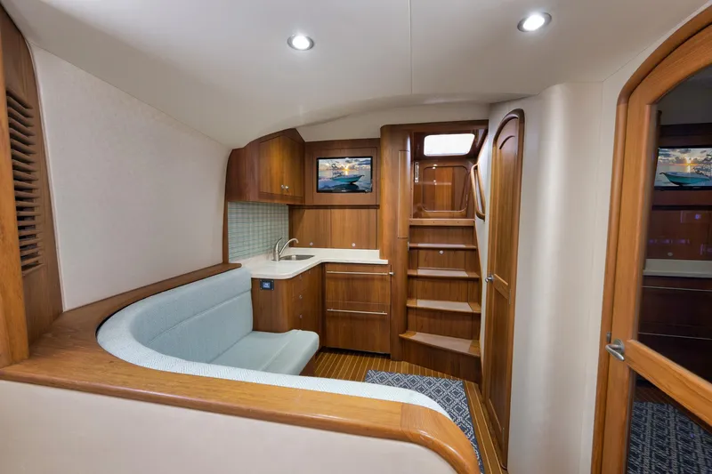 Karma Yacht Photos Pics Luxurious interior of 2019 Winter Custom Yachts 46 Walkaround with wood finish and seating area.