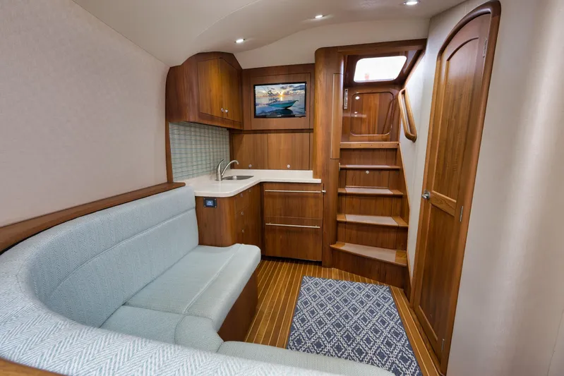 Karma Yacht Photos Pics Luxurious interior of 2019 Winter Custom Yachts 46 Walkaround with wood finish and cozy seating.