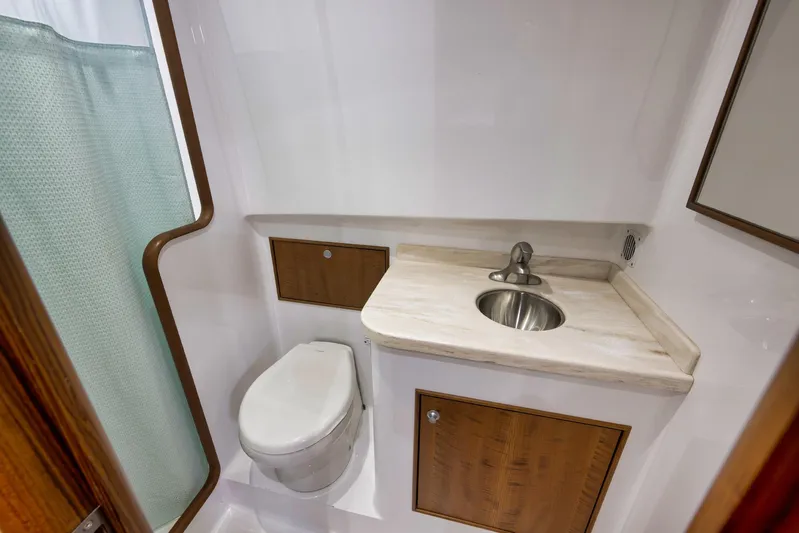 Karma Yacht Photos Pics 2019 Winter Custom Yachts 46 Walkaround bathroom with sink, toilet, and shower curtain.