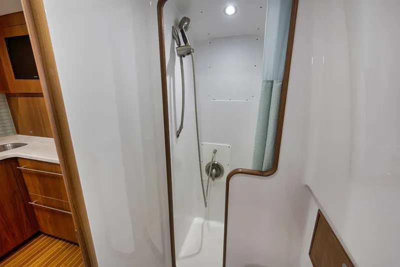 Karma Yacht Photos Pics 2019 Winter Custom Yachts 46 Walkaround shower with modern fixtures and wooden accents.