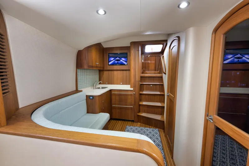 Karma Yacht Photos Pics Luxurious interior of 2019 Winter Custom Yachts 46 Walkaround with wood finish and seating area.
