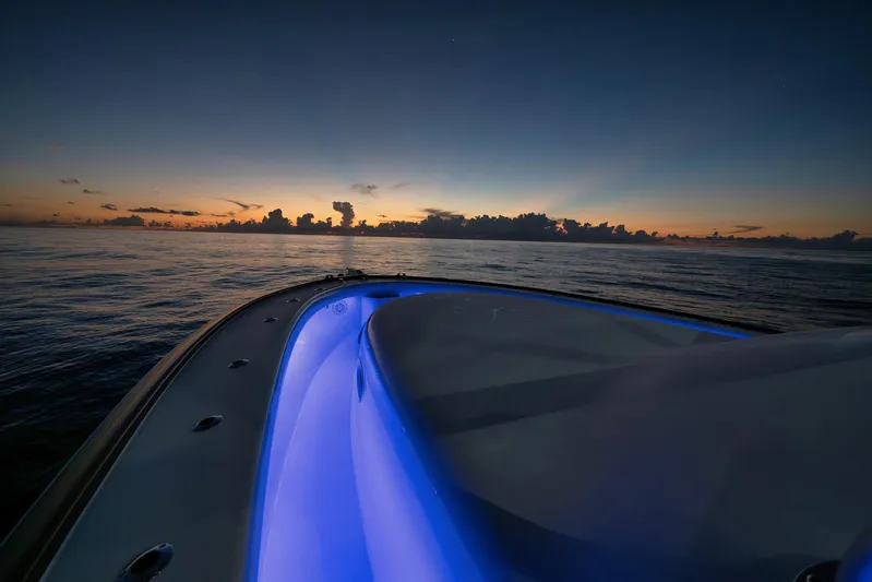 Karma Yacht Photos Pics 2019 Winter Custom Yachts 46 Walkaround at sunset, featuring illuminated deck and serene ocean view.