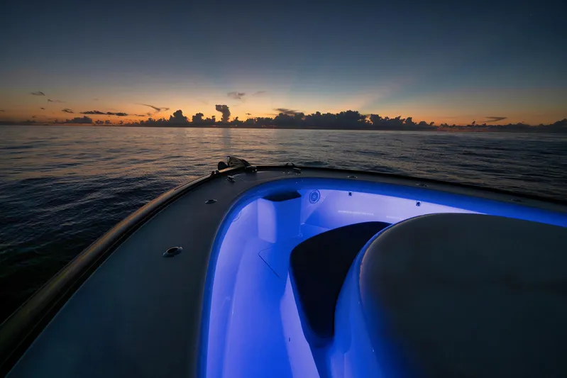 Karma Yacht Photos Pics 2019 Winter Custom Yachts 46 Walkaround at sunset, featuring illuminated deck and serene ocean view.